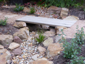 Blackburn dry creek bed with timber bridge and rocks.